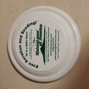 White Frisbee advertising Free Aeration and Seeding